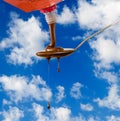 Image of liquid chocolate on a spoon against the sky