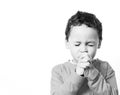 Little boy praying with his hands clenched together