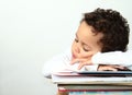 Little boy sleeping on a pile of books Royalty Free Stock Photo