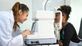 Image of little girl checking eyesight on auto refractor in ophthalmologist clinic. Eye health check and ophthalmology Royalty Free Stock Photo