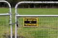 Old No Trespassing Sign and Locked Metal Gate Royalty Free Stock Photo