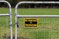 Old No Trespassing Sign and Locked Metal Gate