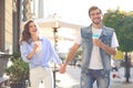 Image of lovely happy couple in summer clothes smiling and holding hands together while walking through city street Royalty Free Stock Photo