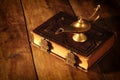 Image of magical aladdin lamp and old books. Lamp of wishes. Royalty Free Stock Photo