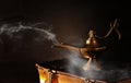 Image of magical aladdin lamp on old books. Lamp of wishes Royalty Free Stock Photo