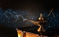 Image of magical aladdin lamp on old books. Lamp of wishes. Royalty Free Stock Photo