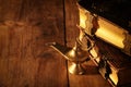 Image of magical aladdin lamp and old books. Lamp of wishes. Royalty Free Stock Photo