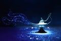 Image of magical mysterious aladdin lamp with glitter smoke. Dark background and dramatic light Royalty Free Stock Photo