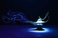 Image of magical mysterious aladdin lamp with glitter smoke. Dark background and dramatic light Royalty Free Stock Photo