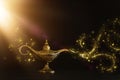 Image of magical mysterious aladdin lamp with glitter sparkle smoke over black background. Lamp of wishes Royalty Free Stock Photo