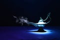 Image of magical mysterious aladdin lamp with smoke. Dark background and dramatic light Royalty Free Stock Photo