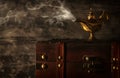 Image of magical mysterious aladdin lamp with smoke over black background. Lamp of wishes. Royalty Free Stock Photo