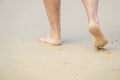 male bare feet in the wet sand