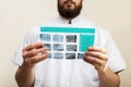 Image of male doctor or dentist holding and looking at old dental x-ray, analyzing Royalty Free Stock Photo