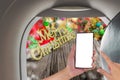 image of male hand using phone on the plane and Christmas ornaments Royalty Free Stock Photo