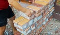 Image of Male hands lifting bricks, Stacked pile of bricks, Recycled bricks Royalty Free Stock Photo