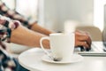 Image of male hands working and typing on a laptop keyboard with a cup of coffee on a wooden table, Man working from home Royalty Free Stock Photo