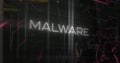 Image of malware text over data processing and server room