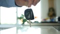 Image with a Man Giving Car Key with Remote Control to Another Person Royalty Free Stock Photo