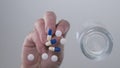 Image with Man Hands Taking Some Medicine Pills From Table Glass Surface Royalty Free Stock Photo