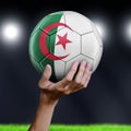 Man holding Soccer ball with Algerian flag