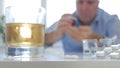 Image with a Man Mixing Alcohol Medical Pills and Cigarettes Royalty Free Stock Photo