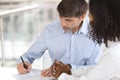 Image of man putting signature signing paper at meeting concept.