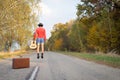 Image of man in shorts hitchhiking on sunny fall Royalty Free Stock Photo