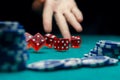 Image of man throwing dice on table with chips in casino Royalty Free Stock Photo