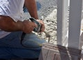 Image of man worker holding ceramic tile drill machine while drilling old tiles Royalty Free Stock Photo