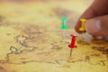 Image man& x27;s hand attached pins to a map, showing location or travel destination. selective focus. Royalty Free Stock Photo