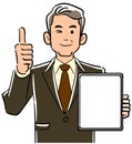 A management man in a suit holding a tablet PC with a blank screen and thumbs up