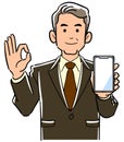 A managerial man holding a smartphone and giving an OK sign