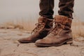 Image of mans legs in old boots. Concept of selling shoes. Autumn time. Horizontal view. Outdoor shot. Footwear Royalty Free Stock Photo