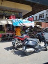 Image of market place where shopkeepers and vehicles are seen in India