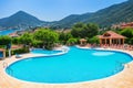Marmaris, Turkey - 21, : Swimming pool at the hotel, a hill and a man on it made with Generative AI