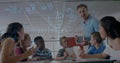Image of math formulas moving over diverse male teacher and pupils working on laptop Royalty Free Stock Photo