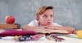 Image of math formulas over thoughtful caucasian boy learning at school Royalty Free Stock Photo