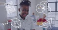 Image of maths icons over smiling african american schoolboy smiling in class