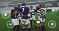 Image of media icons over diverse male rugby team in huddle at stadium Royalty Free Stock Photo
