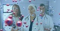 Image of a medical staff team in hospital with coronavirus cells floating on the foreground Royalty Free Stock Photo