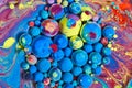 Mesmerizing cluster of blue and rainbow orbs on multicolored silky surface