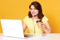 Image of miling freelance operator working online with headsets and laptop computer at office or home. Cheerful call center female Royalty Free Stock Photo