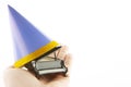 Image of miniature piano paper hat hand white background