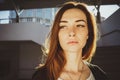 An image of a modern red-haired girl with freckles. Closeup portrait looking at camera