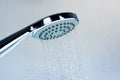 Image of a modern shower head splashing water. Close up background. Royalty Free Stock Photo