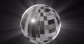 Image of monochrome rotating mirrorball and lights on black background