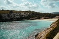 Image moored yachts on bright blue bay Cala Blanca Andratx, Palma de Mallorca, rocky coast breathtaking view, Balearic