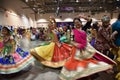 Image with motion blur effect of Girls, man and women dancing wearing traditional Indian folk dress during Navratri festival