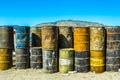 Image of old oil barrels in piles